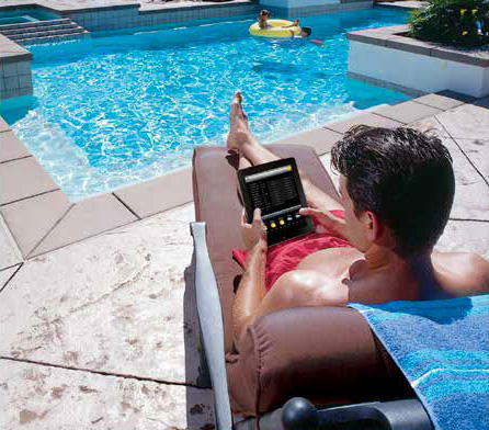 Relaxing in a lounge chair beside a backyard pool during the day