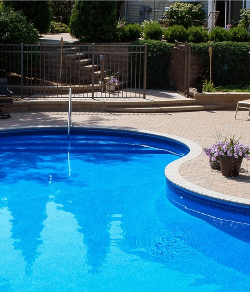 Paver pool patio around a curved Minnesota pool